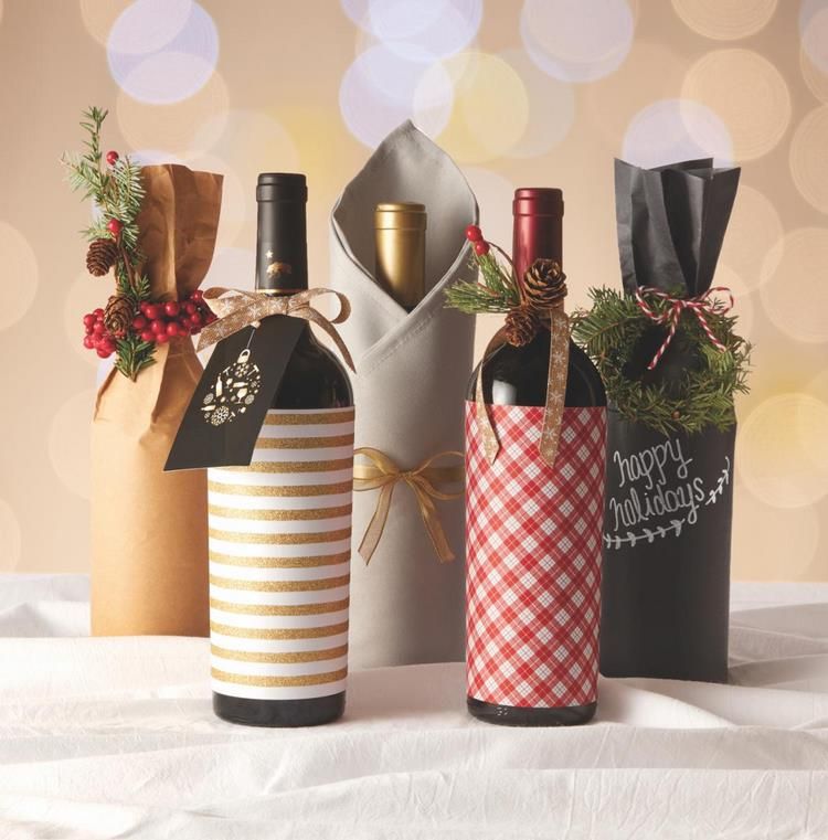 christmas decor with wine bottles three wine bottles wrapped in paper and tied with twine