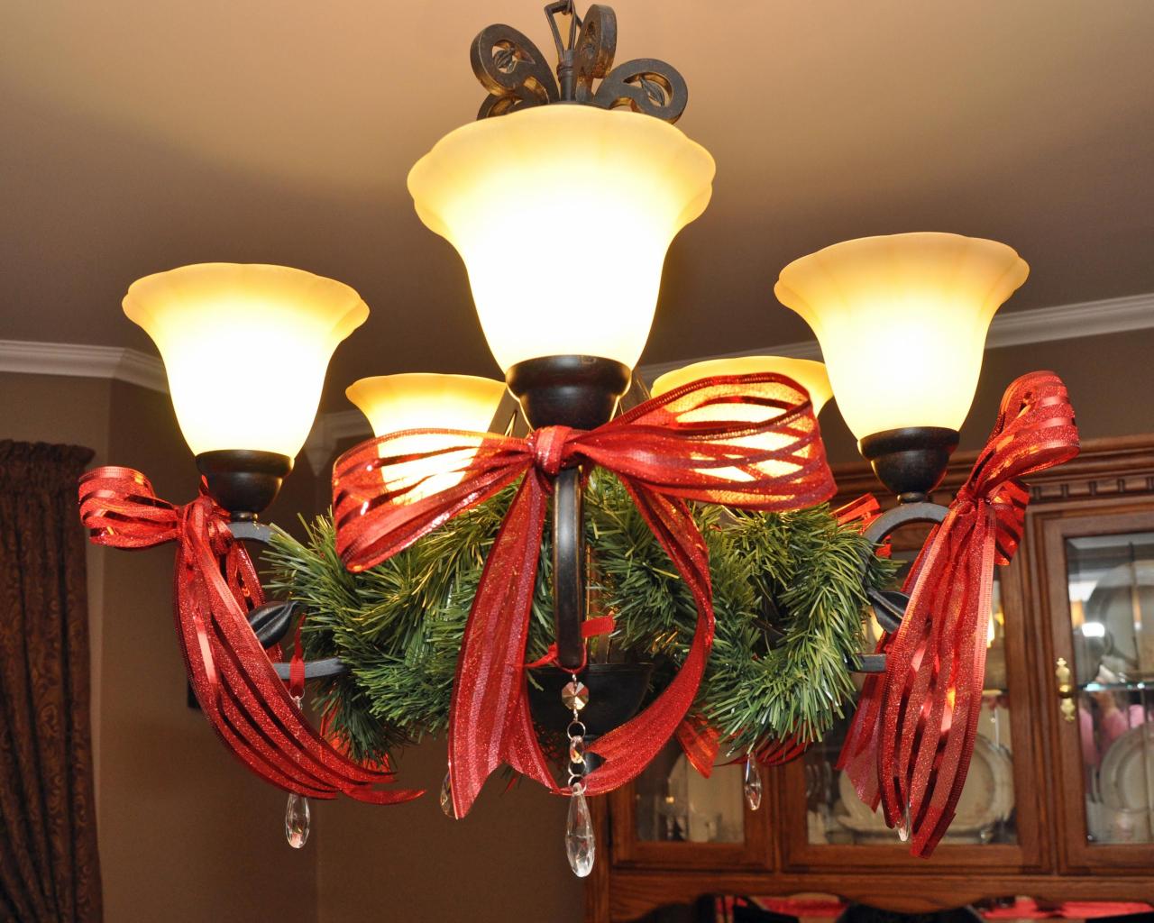 christmas decor for chandelier simple way to decorate a dining room light with garland, red bows and crystal ornaments