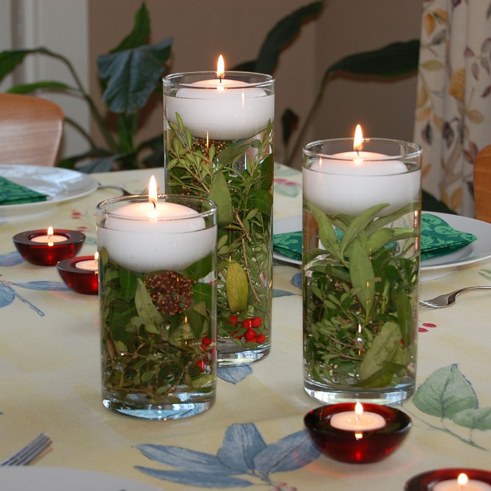 christmas decor with water beads Floating Candles in water filled vase and holiday greens make for a perfect Table Cent… Candle