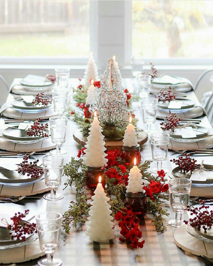 christmas table decoration ideas 2024 a dining room table decorated for christmas with candles and greenery