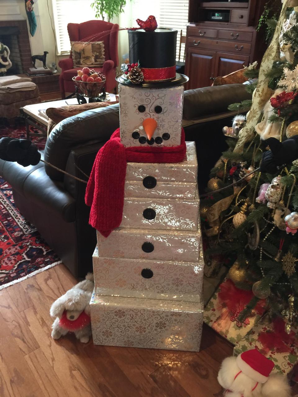 christmas decor ideas cheap a snowman made out of boxes sitting on top of a wooden floor next to a