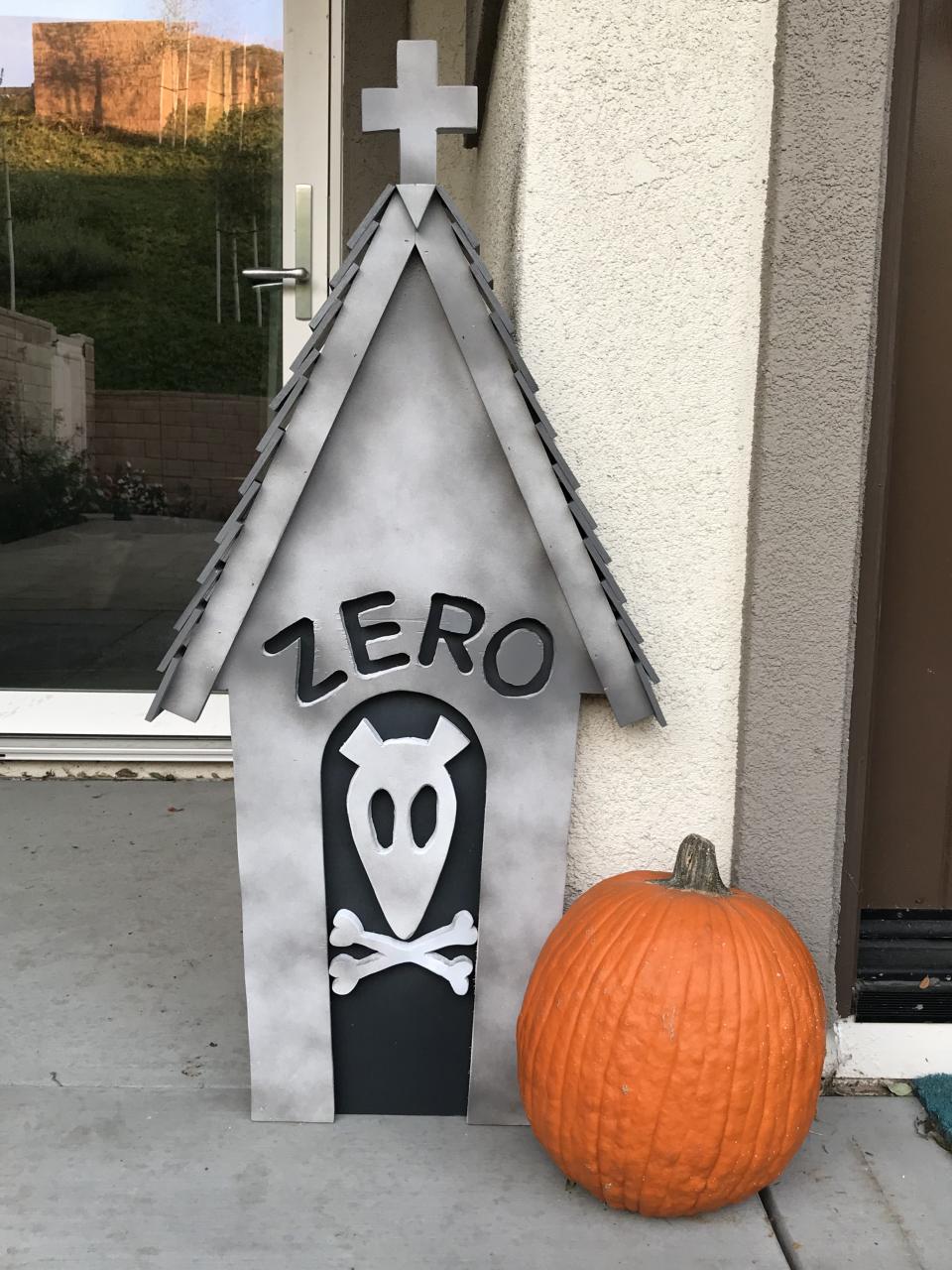 nightmare before christmas zero decor a house shaped like a doghouse next to a pumpkin