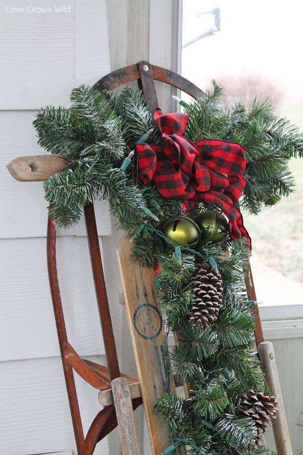 wood sled christmas decor Add some holiday accessories such as pinecones, bells, lights, and