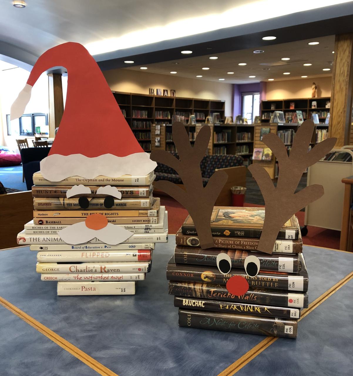 christmas decoration ideas for library two books stacked on top of each other in front of a santa hat and