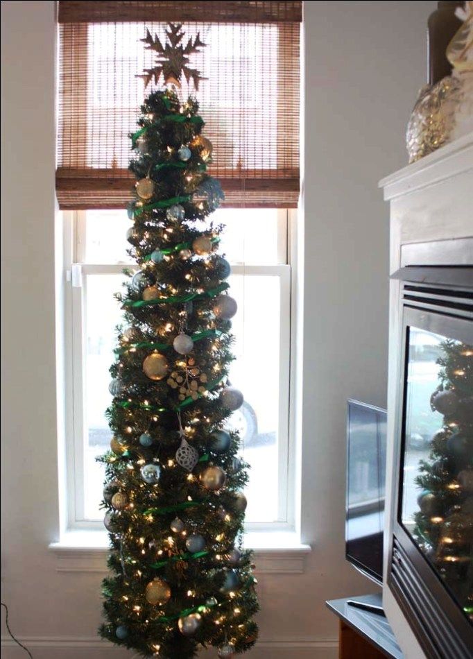 pencil christmas tree decor ideas a decorated christmas tree in front of a window