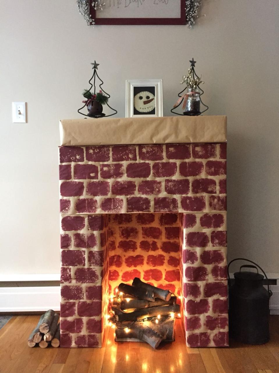 diy fireplace christmas decor Cardboard fireplace, with real wood, and lights as fire. Love, love