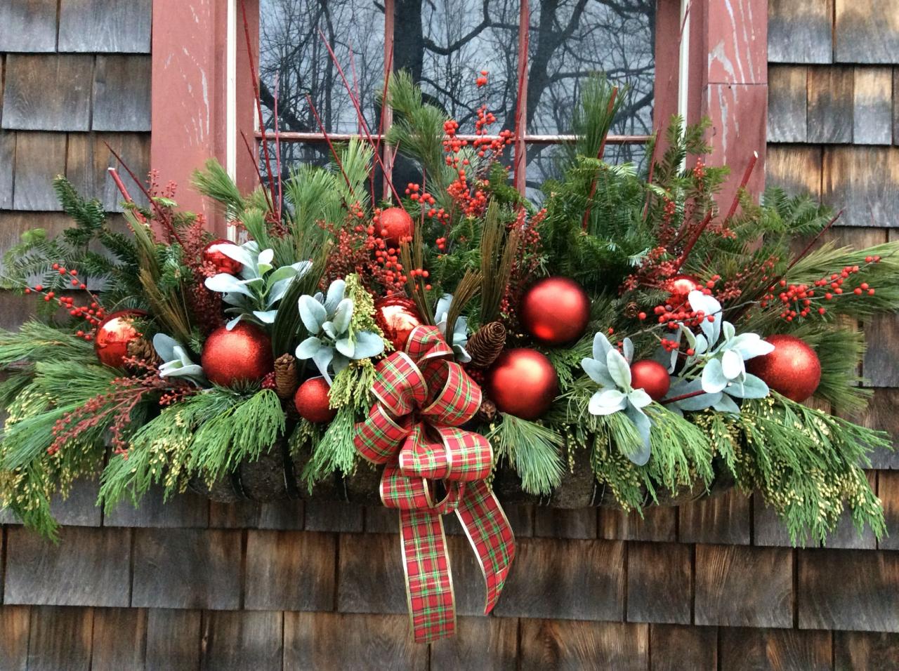 christmas window box decor Holiday window box with fresh greens, berries and shiny red balls