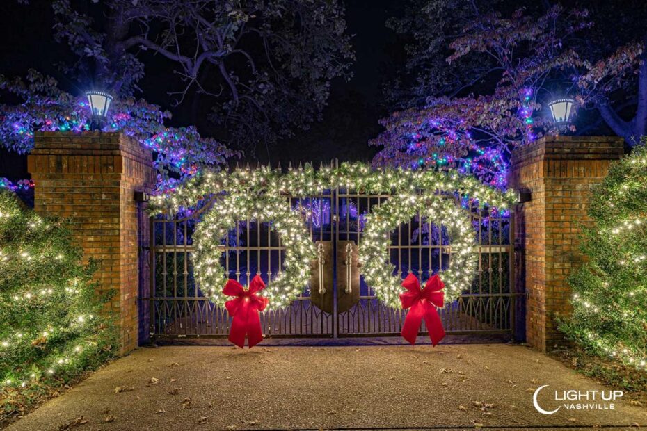 christmas decor for gates Entrance Gate Decorated in Christmas Lights and Greenery