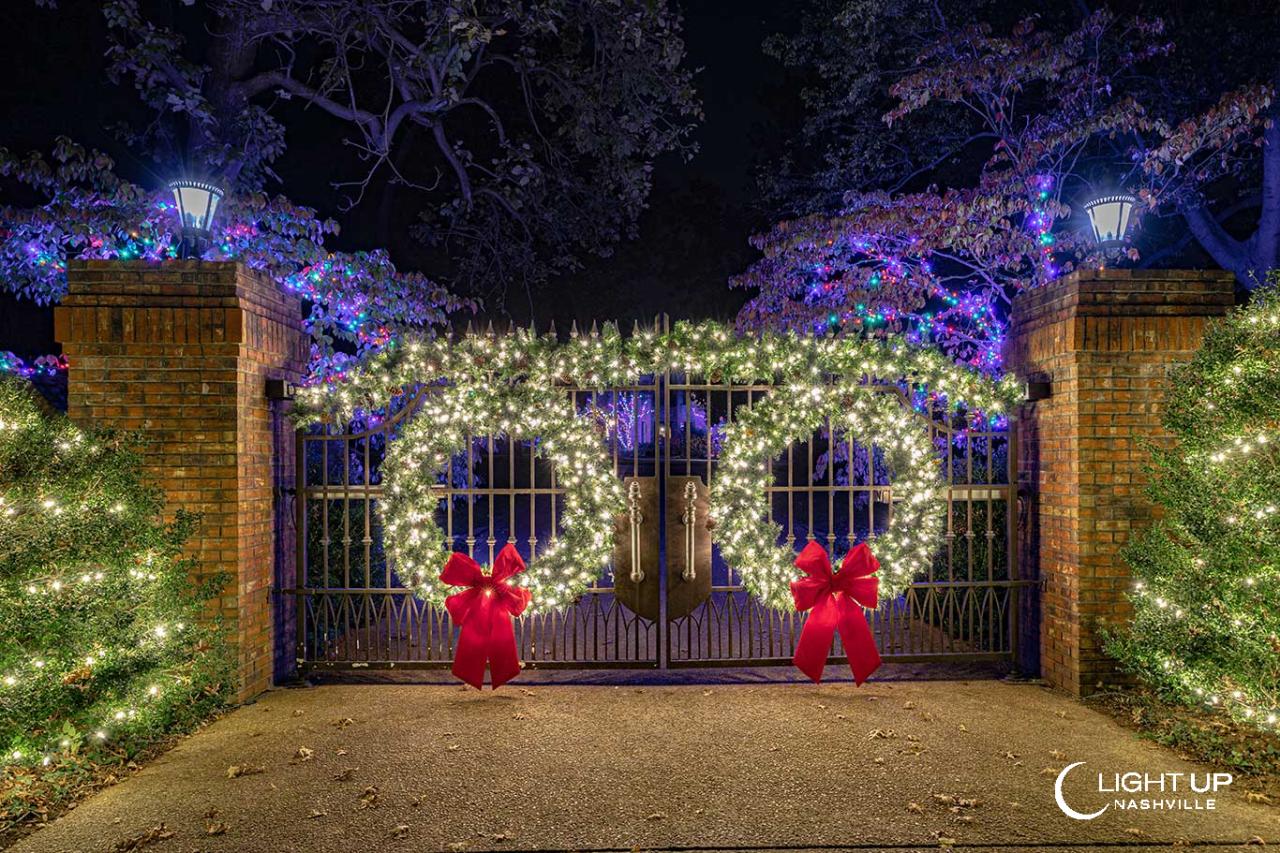 christmas decor for gates Entrance Gate Decorated in Christmas Lights and Greenery